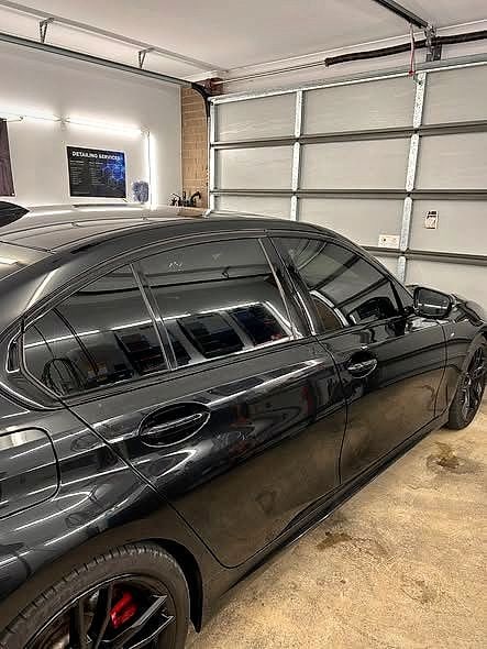 A dark Mercedes tinted in the workshop