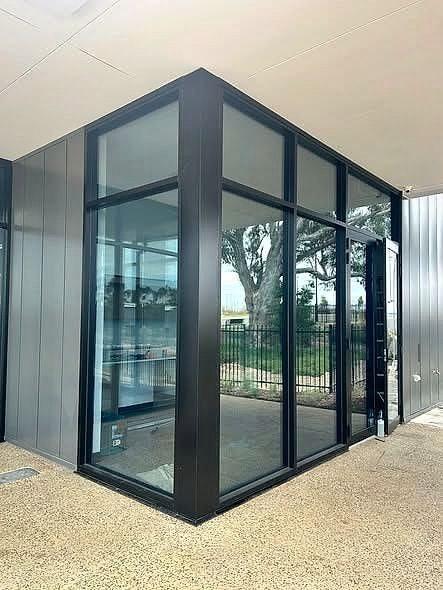 Modern commercial building with dark framed tinted glass tinted by MS Tinting Specialist