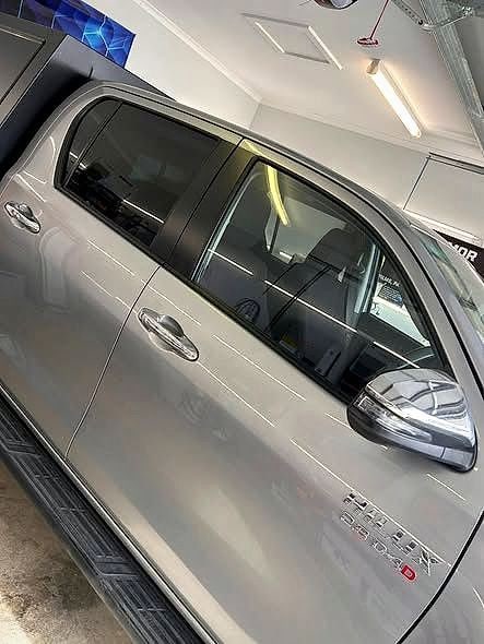 A people mover with tinted side windows in the driveway