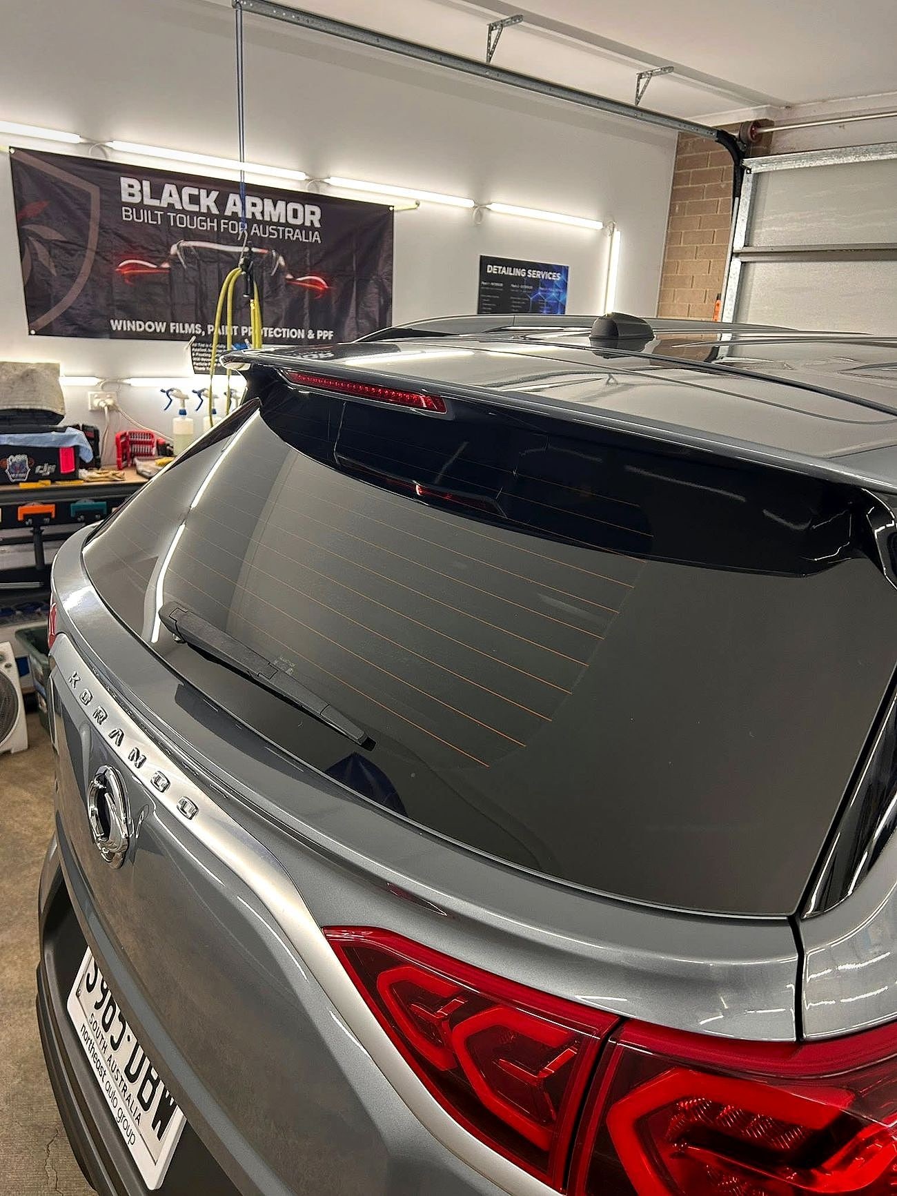 Freshly tinted dark rear glass on an SUV in the MS Tinting Specialist workshop