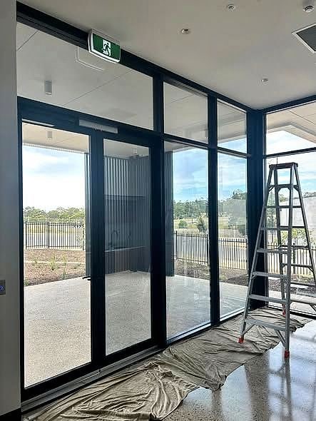 A commercial glass shopfront being tinted